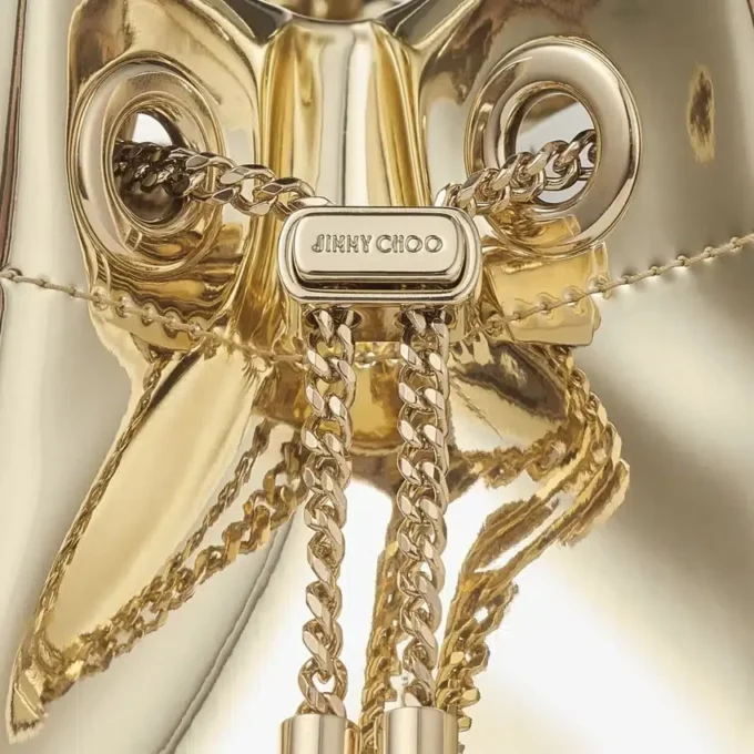 Bon Bon guldspegeltygsminiväska med metallhandtag Bon Bon guldspegeltygsminiväska med metallhandtag
