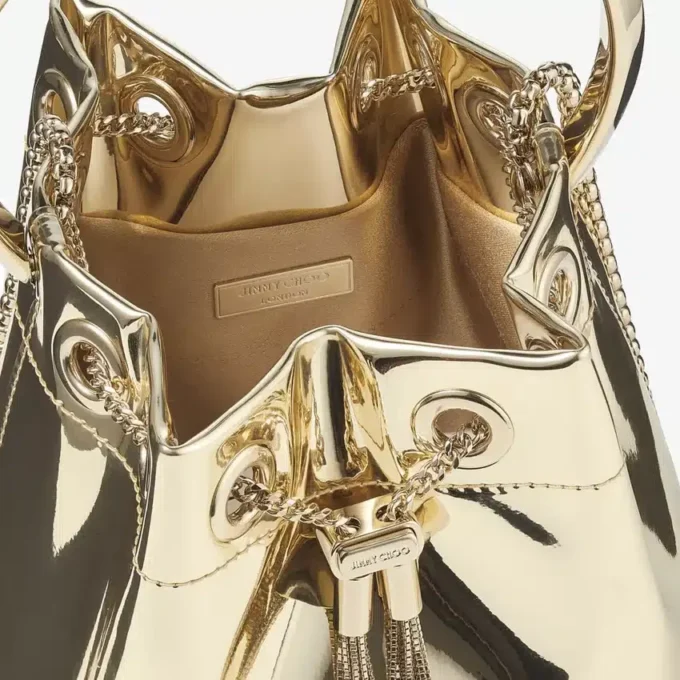 Bon Bon guldspegeltygsminiväska med metallhandtag Bon Bon guldspegeltygsminiväska med metallhandtag