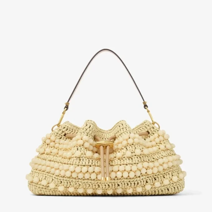 Cinch Medium naturfärgad och cappuccinofärgad raffia-bucketväska med pärlor och slätt kalvskinn Cinch Medium naturfärgad och cappuccinofärgad raffia-bucketväska med pärlor och slätt kalvskinn
