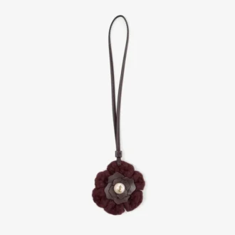 Stickad blomsterberlock Mörkröd stickad blomsterberlock i ull med läderdetaljer