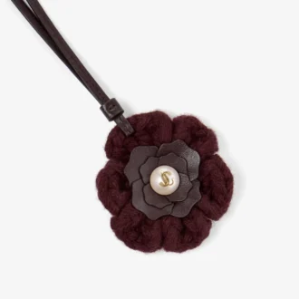 Stickad blomsterberlock Mörkröd stickad blomsterberlock i ull med läderdetaljer